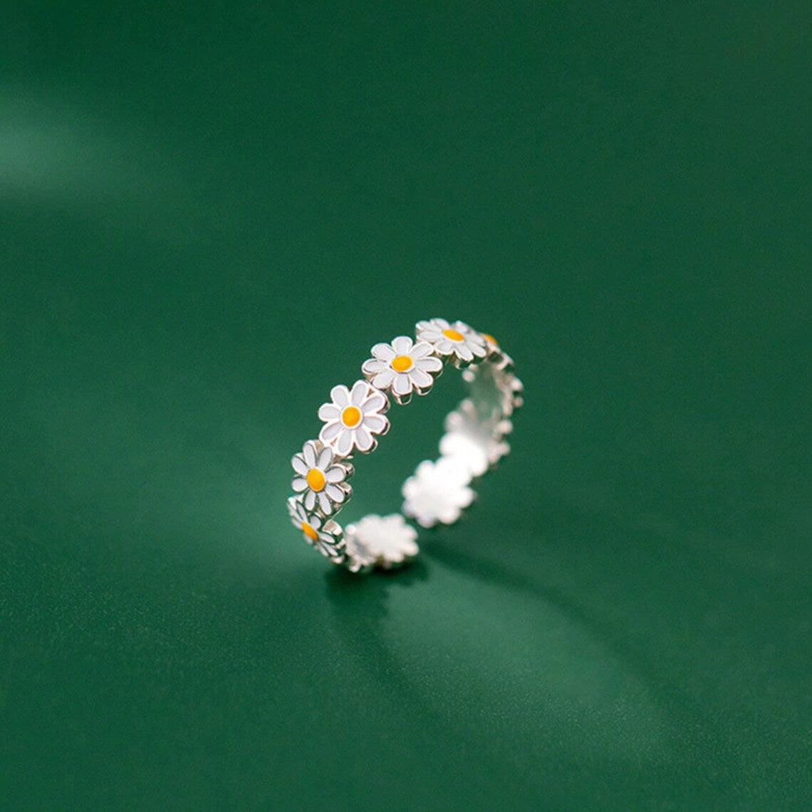 silver ring in the shape of a daisy