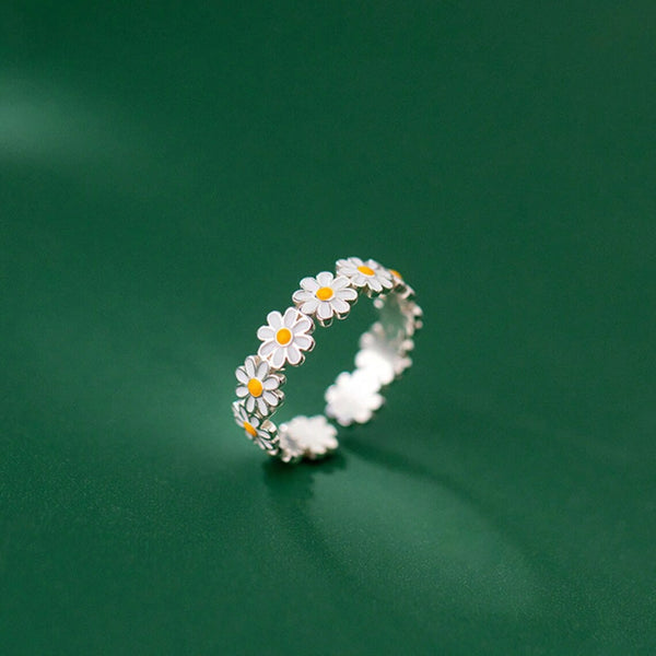 silver ring in the shape of a daisy