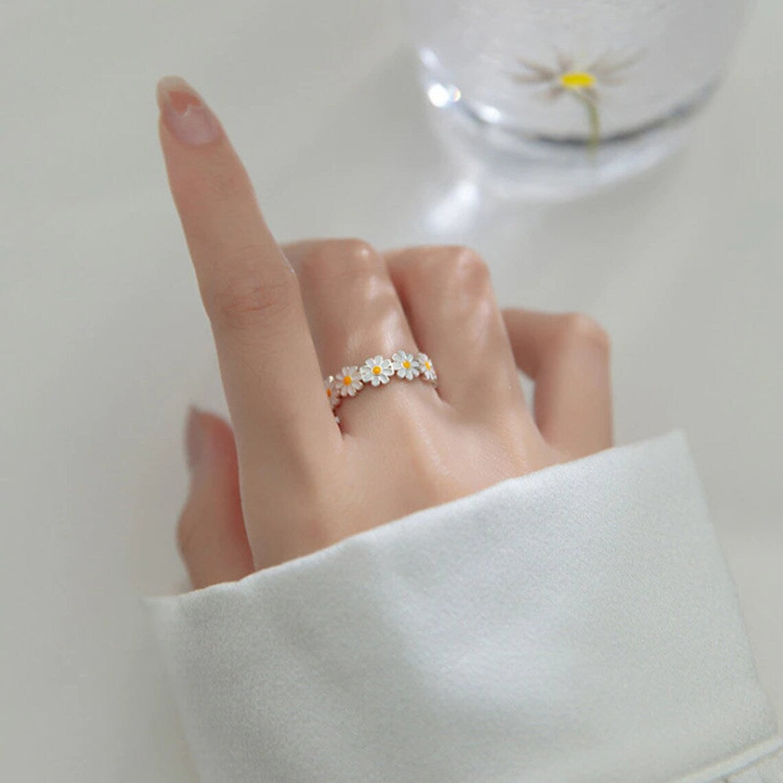 silver ring in the shape of a daisy