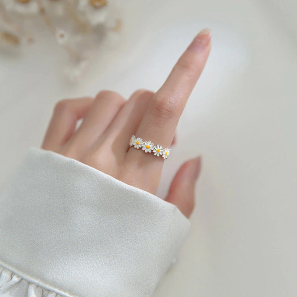 silver ring in the shape of a daisy