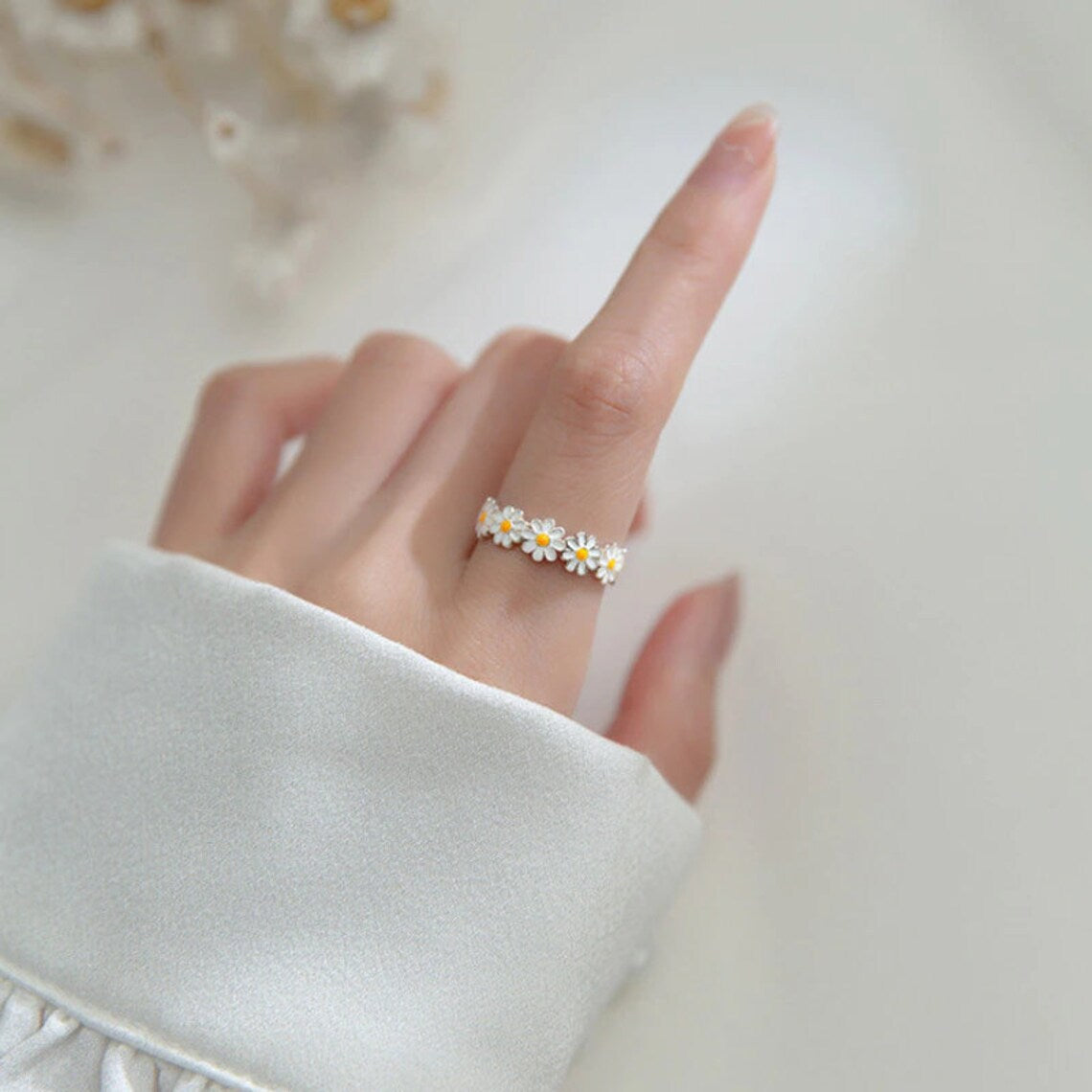 silver ring in the shape of a daisy